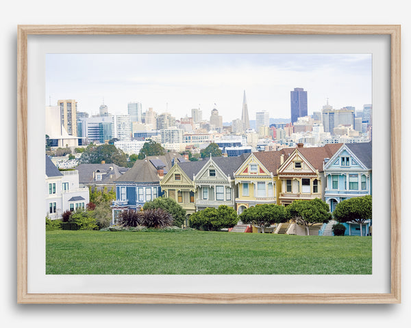 A fine art framed print of the famous colorful painted Ladies Victorian houses in Alamo Square, San Francisco.