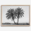 Black and white fine art print of two palm trees in a minimalist desert landscape with clear sky.