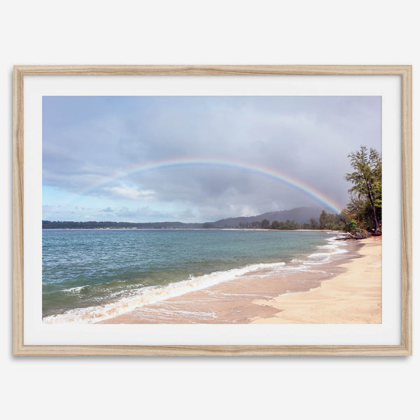 Modern coastal wall art featuring a Kauai beach with a vivid rainbow over turquoise ocean waters and golden sand