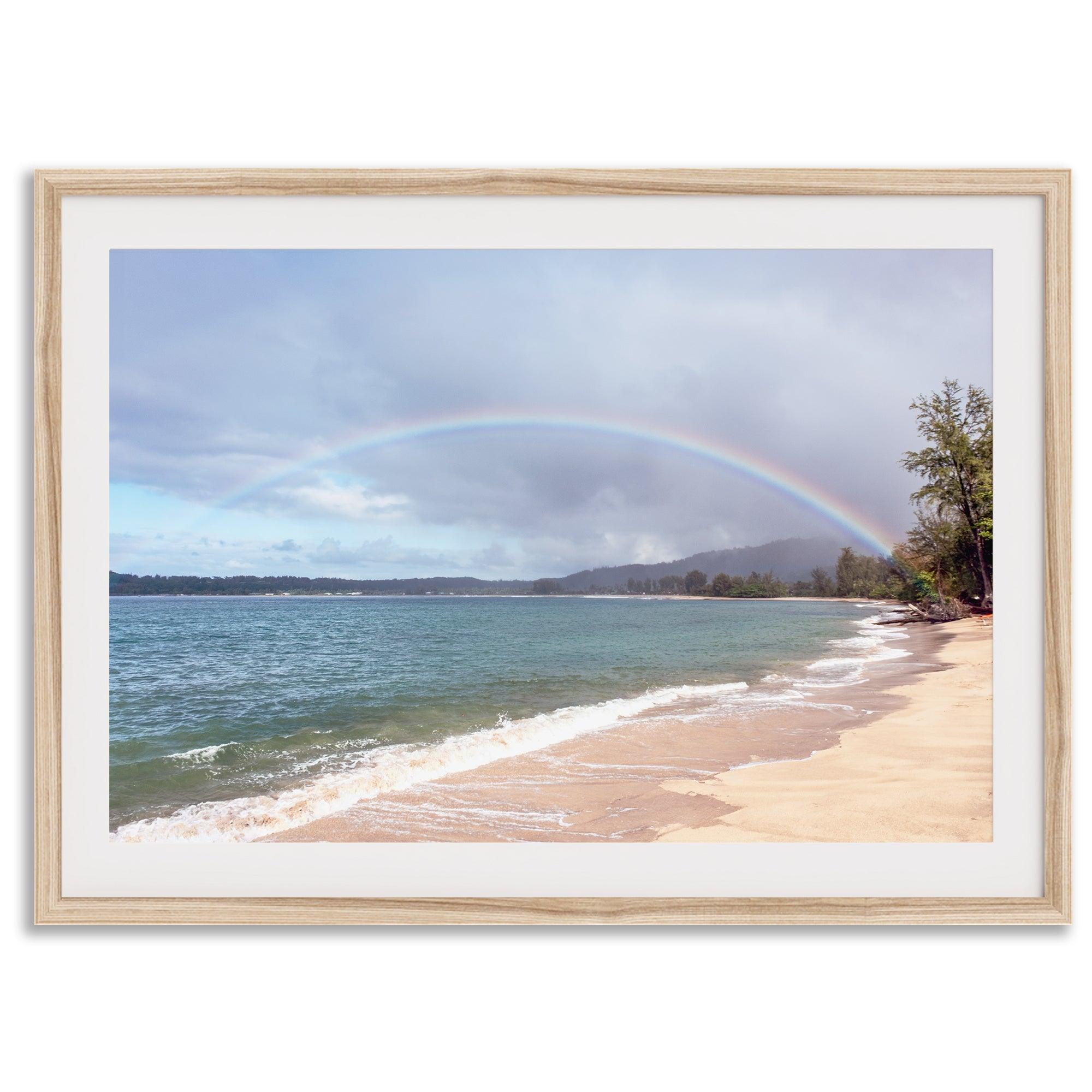 Modern coastal wall art featuring a Kauai beach with a vivid rainbow over turquoise ocean waters and golden sand