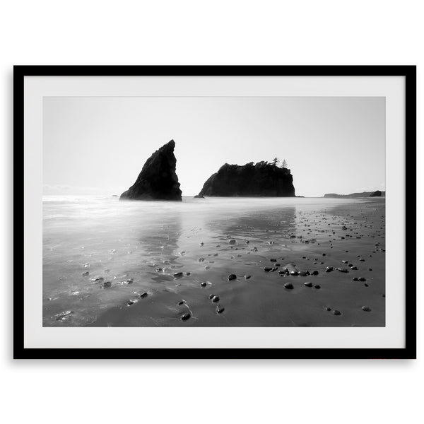 A fine art print of Ruby Beach in Olympic National Park, Washington. This black and white beach wall art features creamy waves in long exposure and dark-shaded towering rocks emerging from the ocean.