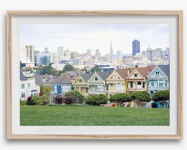 A fine art framed print of the famous colorful painted Ladies Victorian houses in Alamo Square, San Francisco.