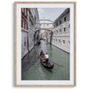 A fine art Venice travel print framed or unframed poster showcasing a Goldola sailing in one of the narrow canals of the old cities of Italy.