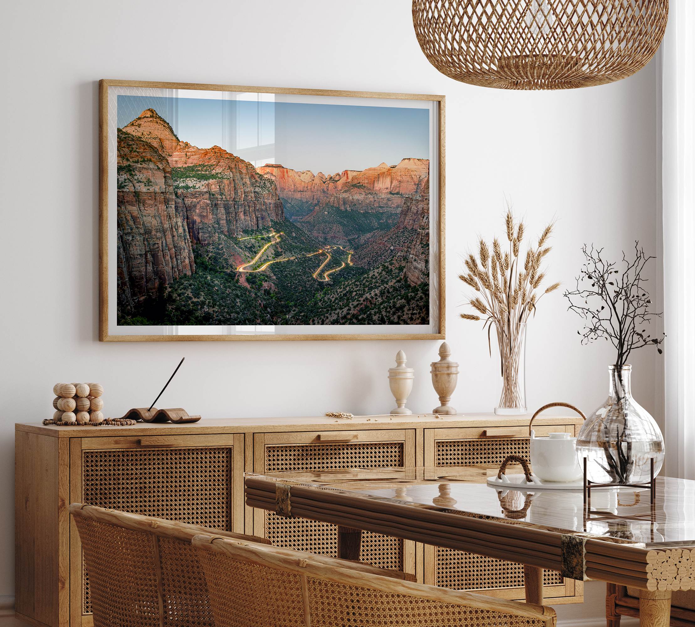 Framed Zion National Park print with winding road illuminated through red cliffs and majestic canyon scenery at dusk.