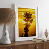 Silhouetted cactus against a vibrant yellow sunset in Joshua Tree National Park, capturing desert beauty.