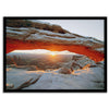 Canyonlands wall art featuring Mesa Arch at sunrise, with sunlight shining through the snow-covered arch over a vast canyon landscape.