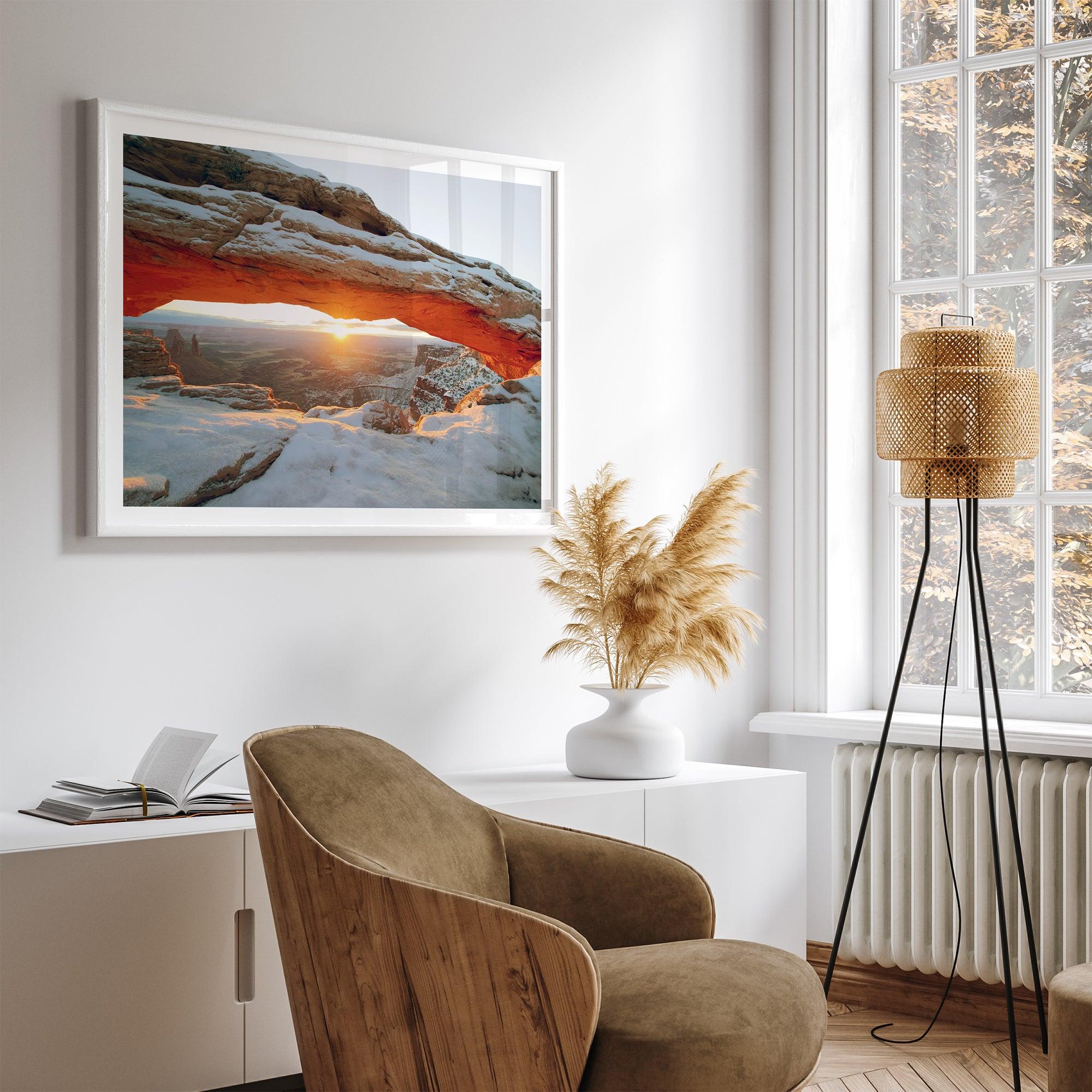 Canyonlands wall art featuring Mesa Arch at sunrise, with sunlight shining through the snow-covered arch over a vast canyon landscape.