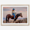 Cowgirl on horseback at sunset in desert landscape – rustic western wall decor print