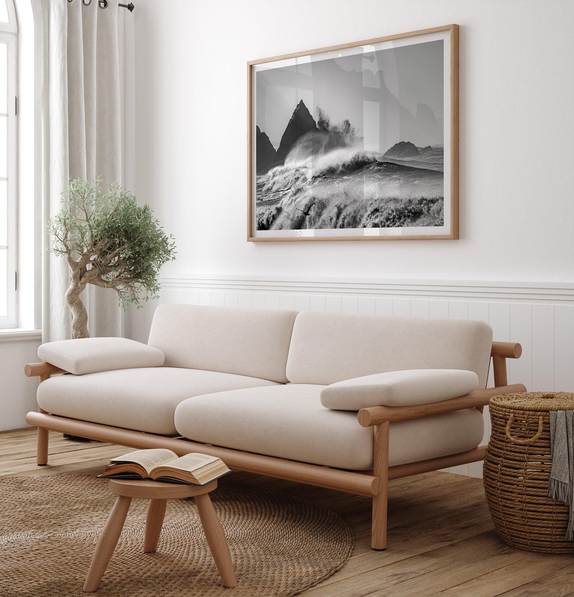 Black and white crashing waves wall art with dramatic ocean spray, jagged cliffs, and a moody atmosphere.