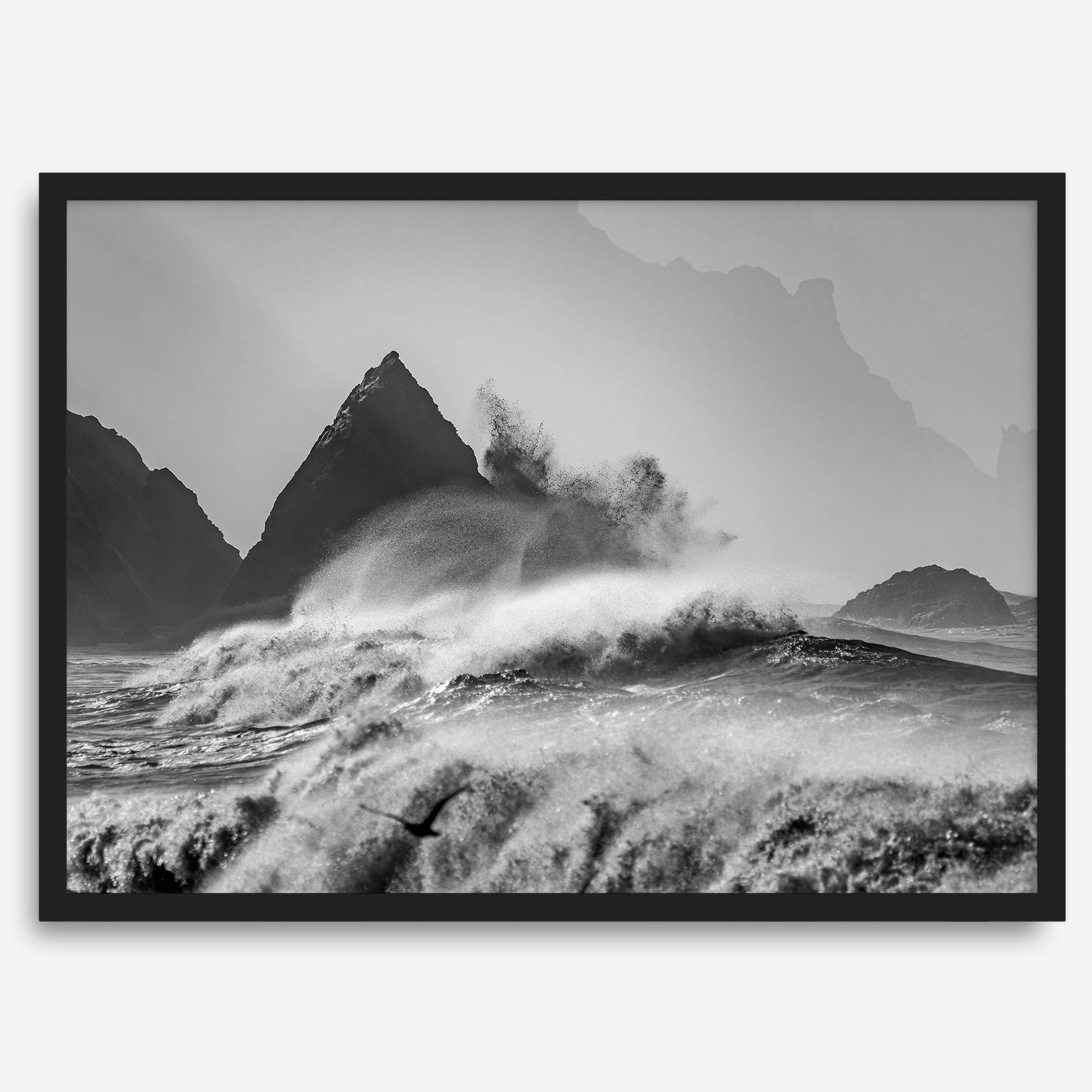 Black and white crashing waves wall art with dramatic ocean spray, jagged cliffs, and a moody atmosphere.