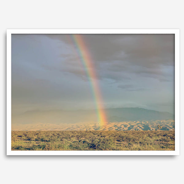 Desert landscape artwork of a rainbow over Arizona sand dunes with distant mountains.
