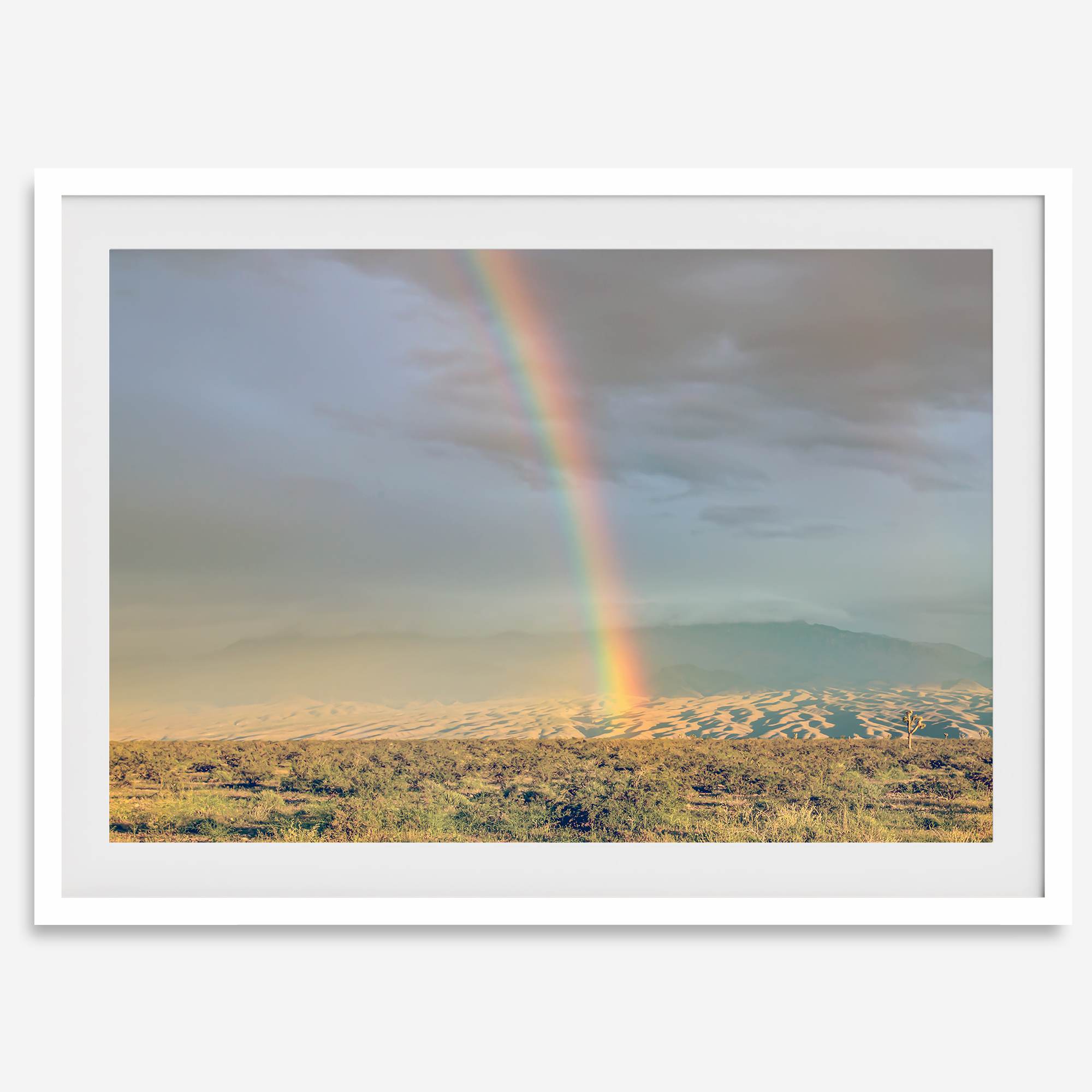 Desert landscape artwork of a rainbow over Arizona sand dunes with distant mountains.