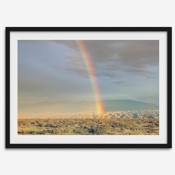 Desert landscape artwork of a rainbow over Arizona sand dunes with distant mountains.
