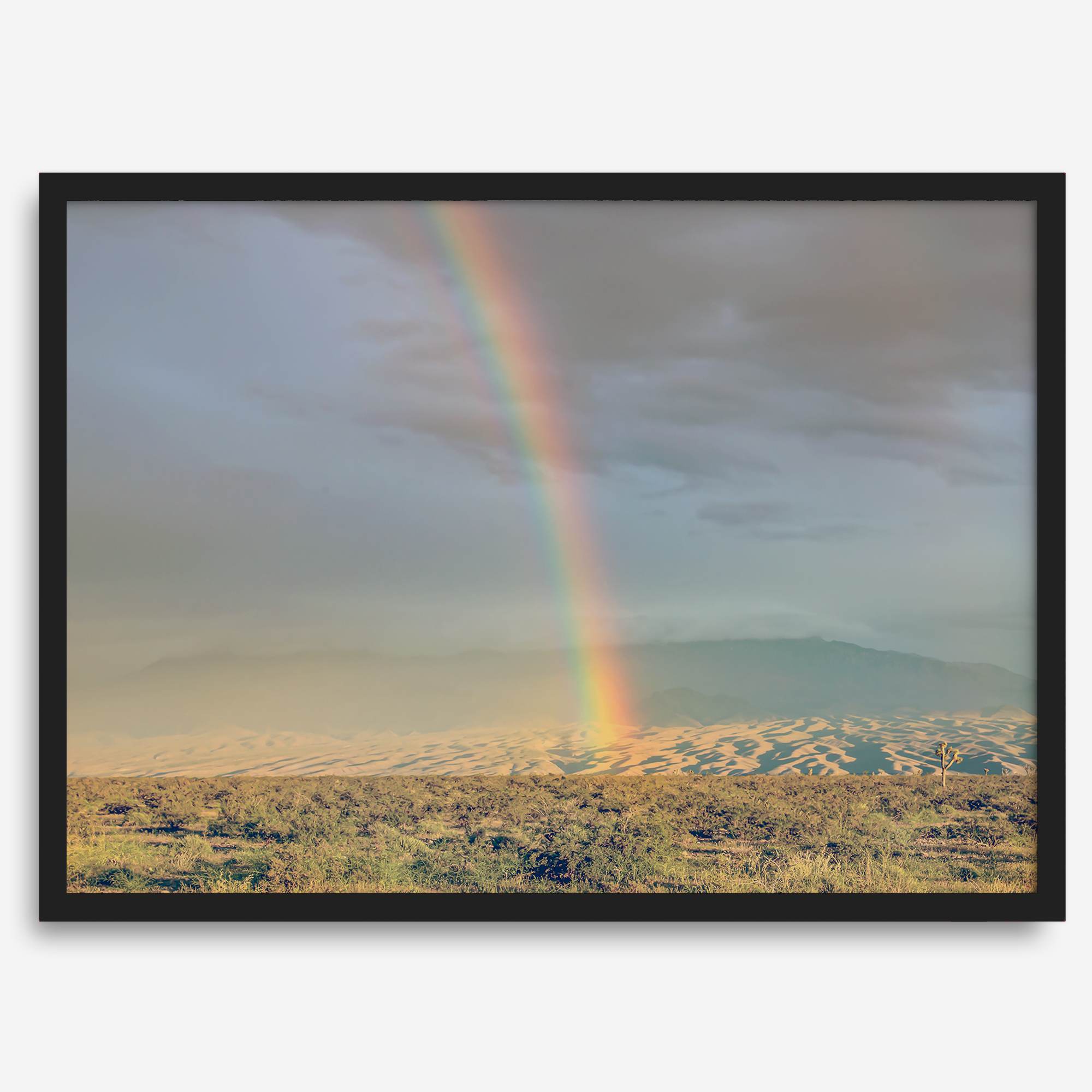 Desert landscape artwork of a rainbow over Arizona sand dunes with distant mountains.