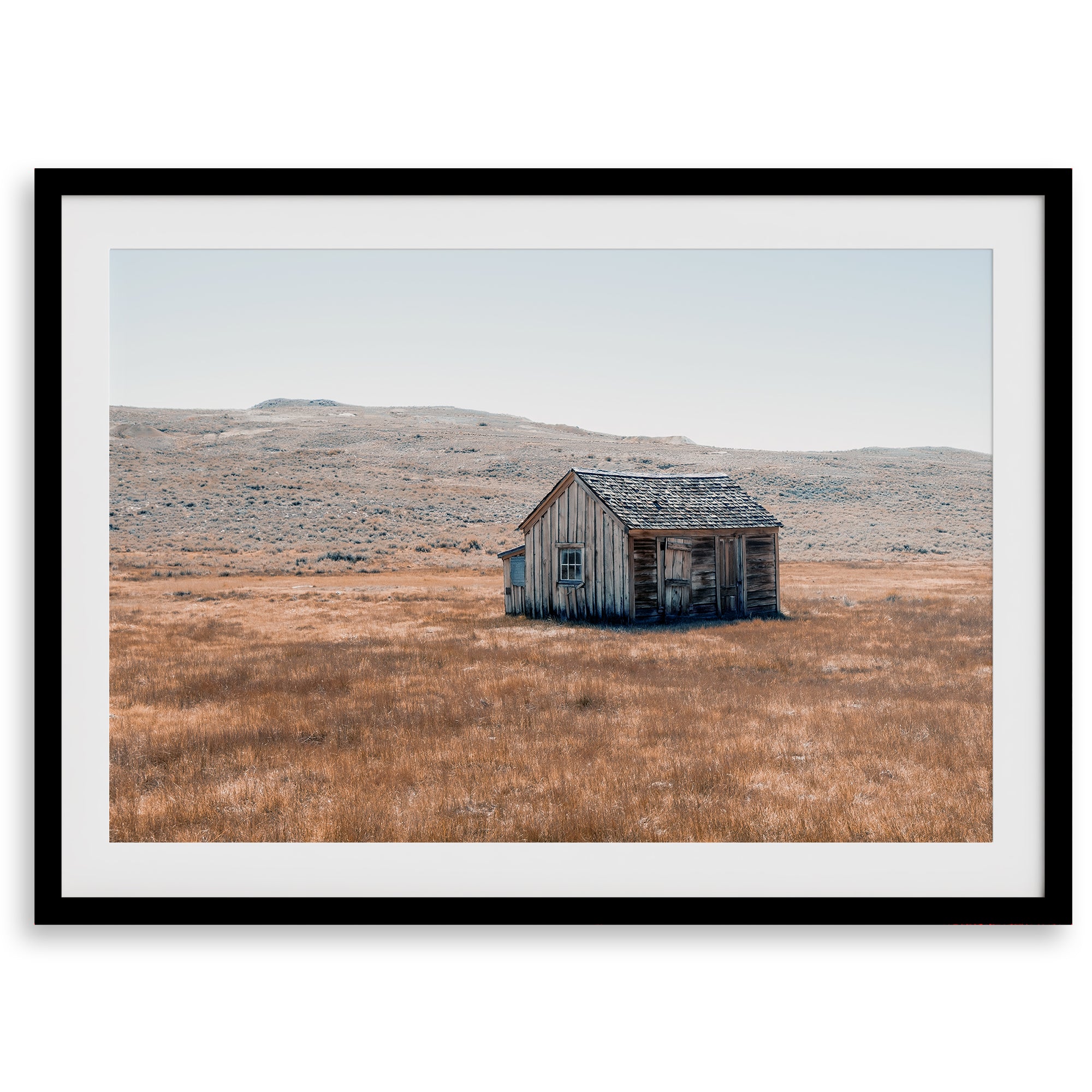 Rustic farmhouse in the Wild West surrounded by golden fields, capturing the essence of American frontier life.