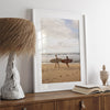 Framed surfers on beach art print featuring Hawaiian coastline and calm morning tones