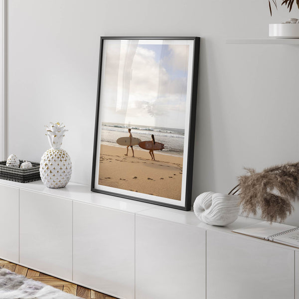 Framed surfers on beach art print featuring Hawaiian coastline and calm morning tones
