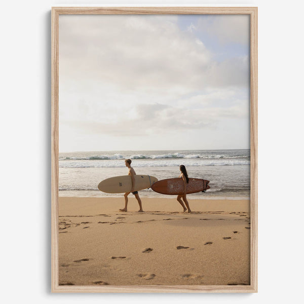 Framed surfers on beach art print featuring Hawaiian coastline and calm morning tones