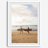 Framed surfers on beach art print featuring Hawaiian coastline and calm morning tones