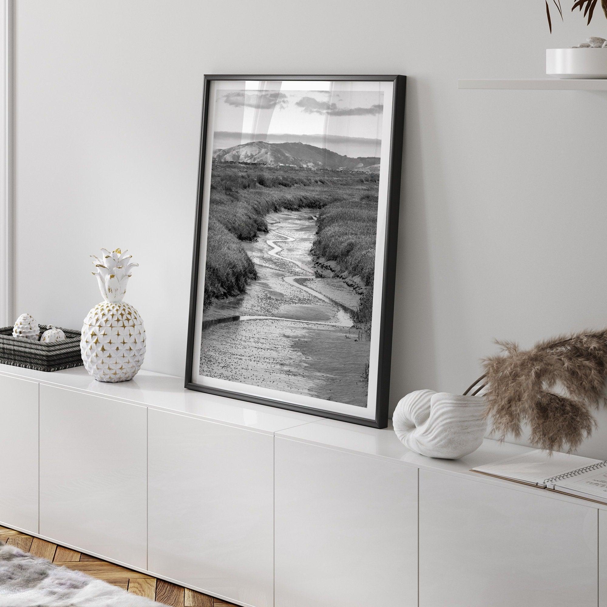 A captivating fine art black and white nature portrait print that transports viewers to the enchanting marshlands of California, where a winding little river weaves its way through a picturesque landscape.