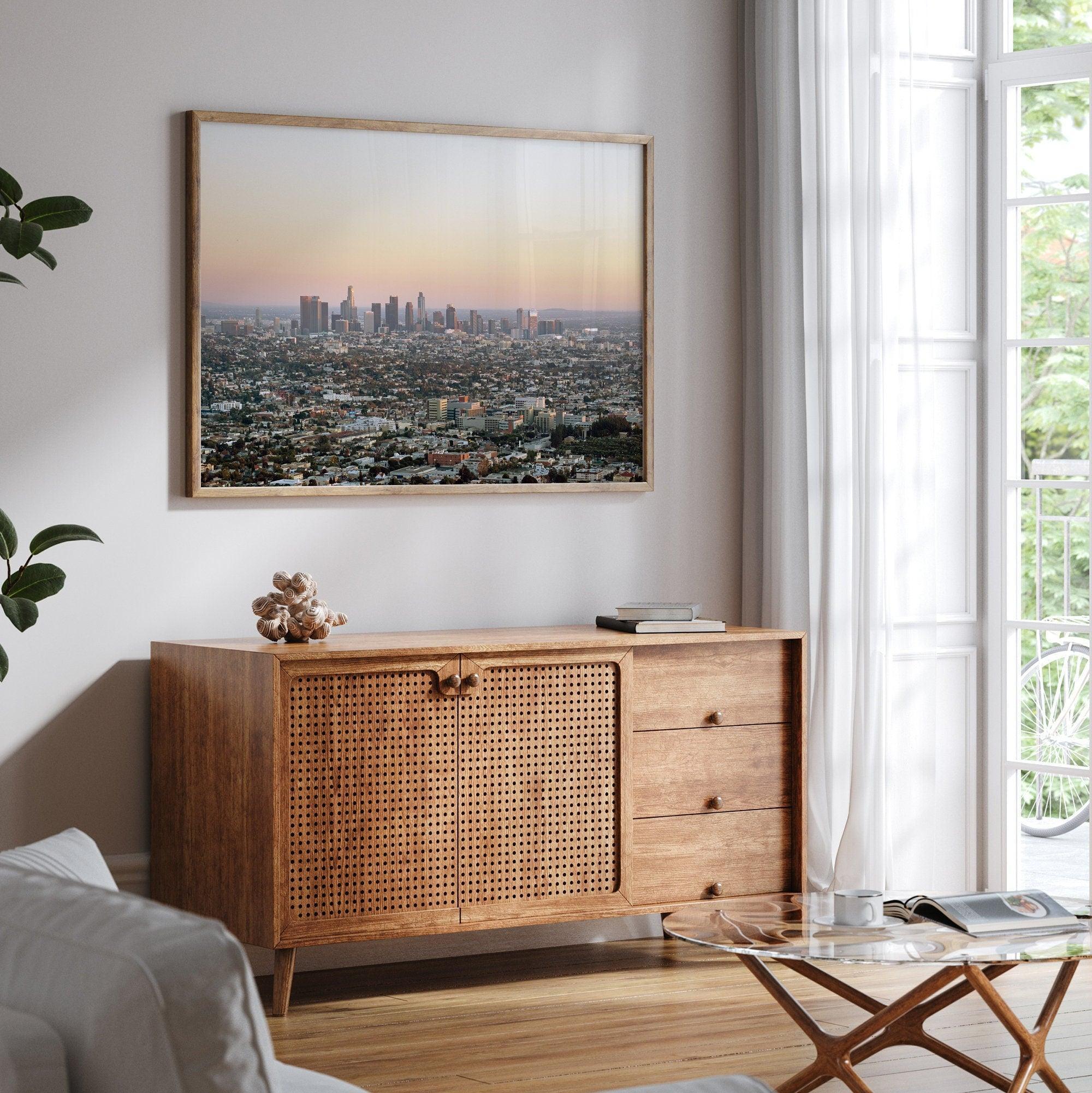 Los Angeles cityscape bathed in a vibrant sunset, showcasing the city's iconic buildings from above