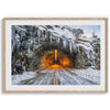 A fine art mountain photography print showing a Yosemite National Park winter scene: A mysterious snow-covered tunnel with an orange glow beckons visitors deeper into the park.