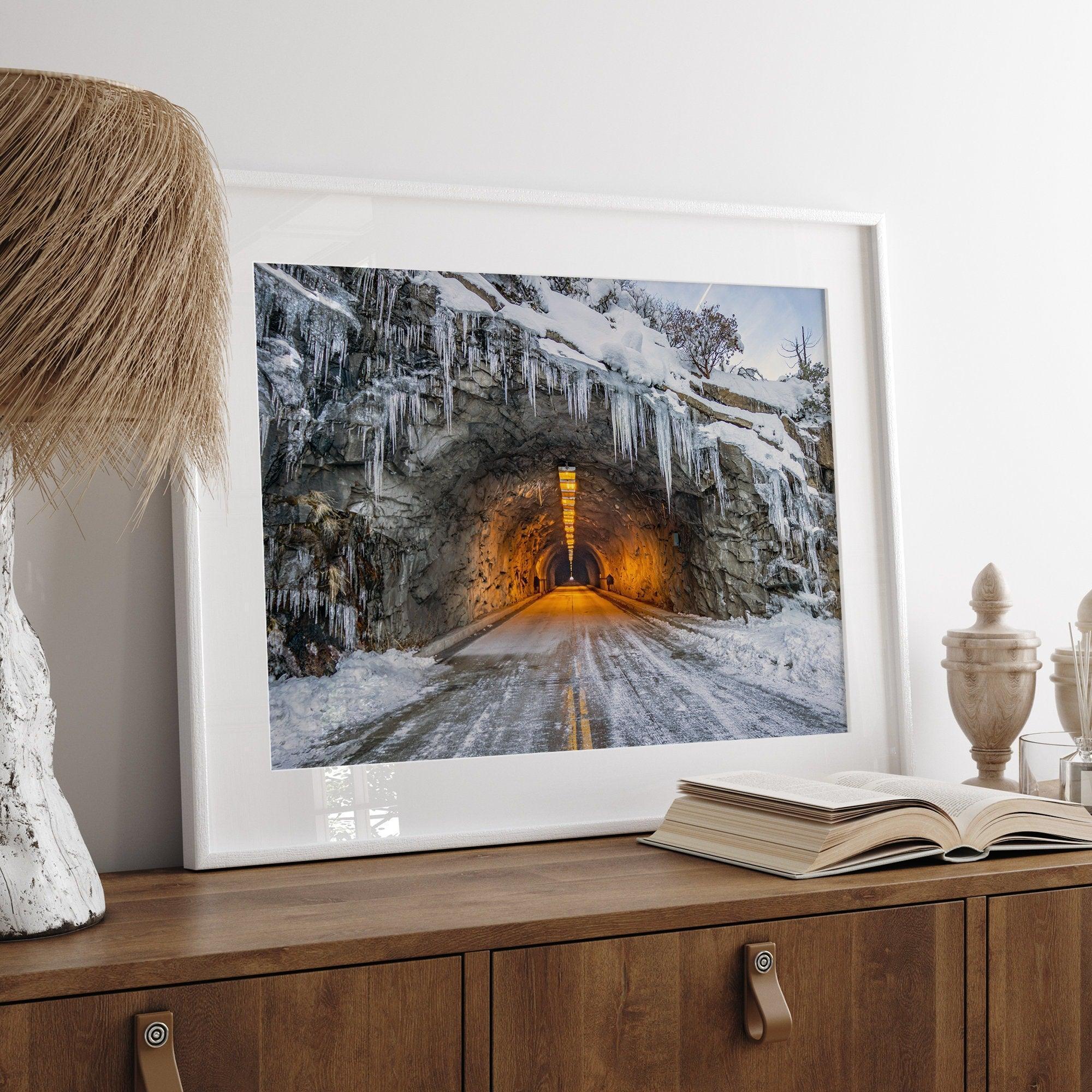 A fine art mountain photography print showing a Yosemite National Park winter scene: A mysterious snow-covered tunnel with an orange glow beckons visitors deeper into the park.