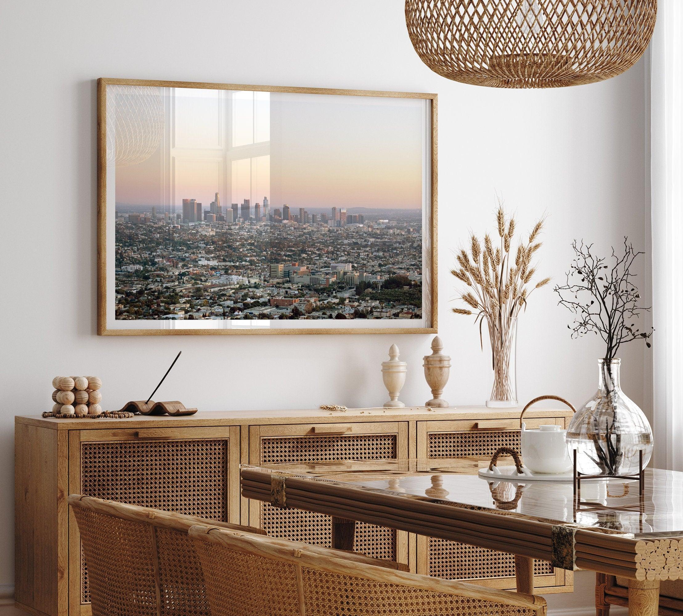 Los Angeles cityscape bathed in a vibrant sunset, showcasing the city's iconic buildings from above