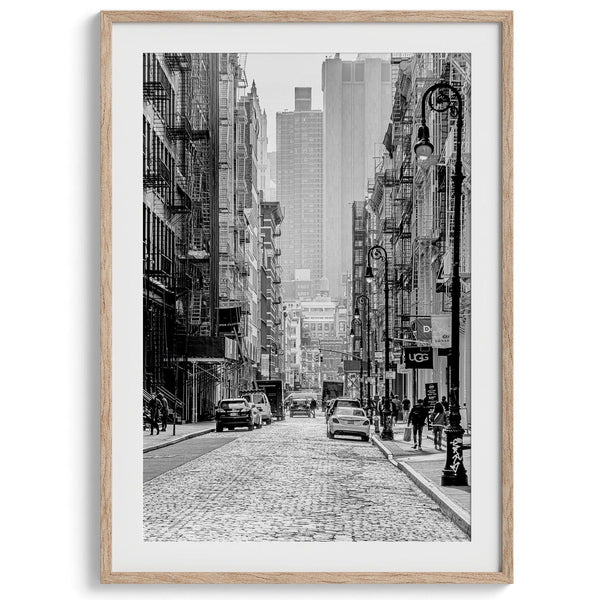 A fine art vertical photography print of a bustling NYC street with unique NYC architecture and fire escape stairs.
