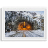 A fine art mountain photography print showing a Yosemite National Park winter scene: A mysterious snow-covered tunnel with an orange glow beckons visitors deeper into the park.