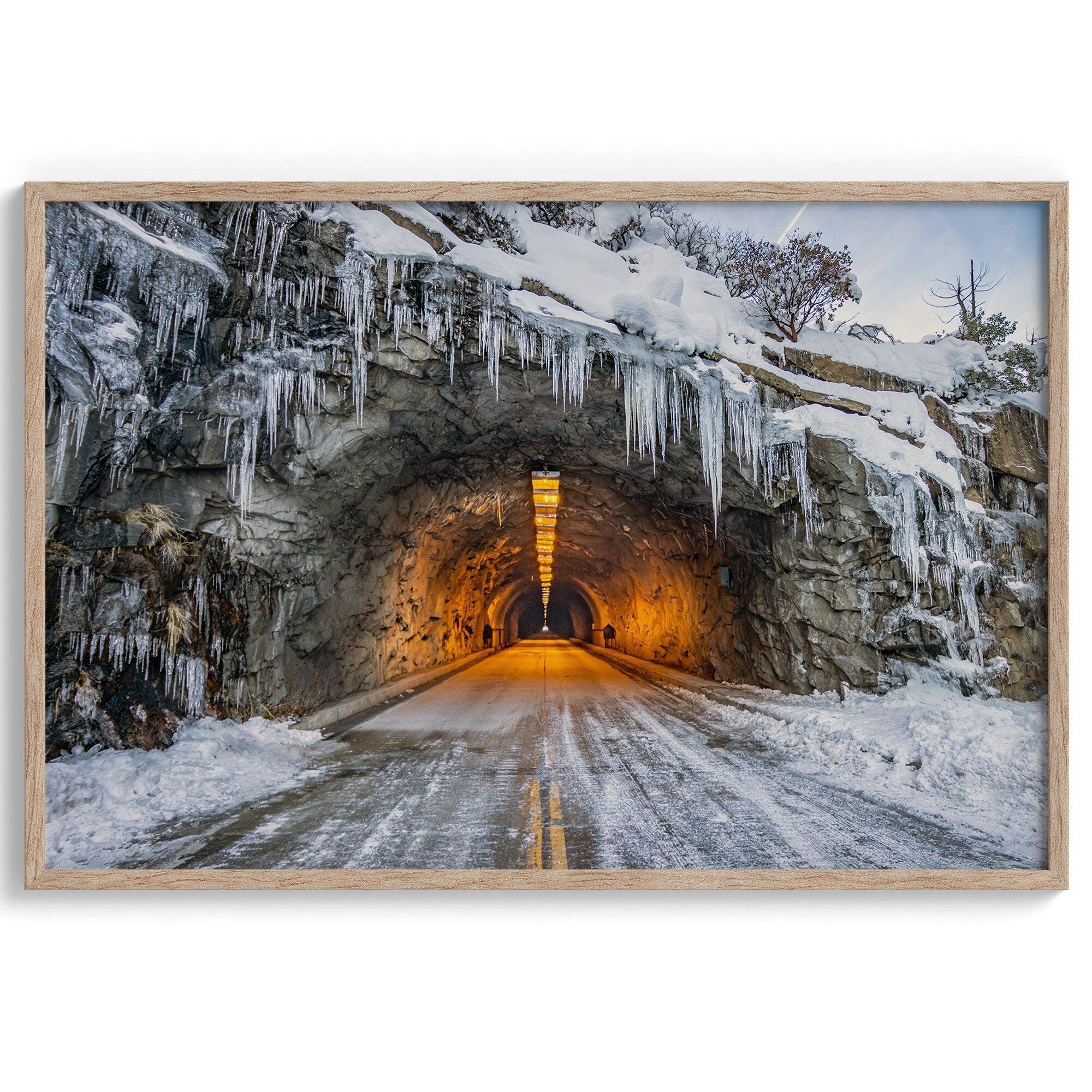 A fine art mountain photography print showing a Yosemite National Park winter scene: A mysterious snow-covered tunnel with an orange glow beckons visitors deeper into the park.