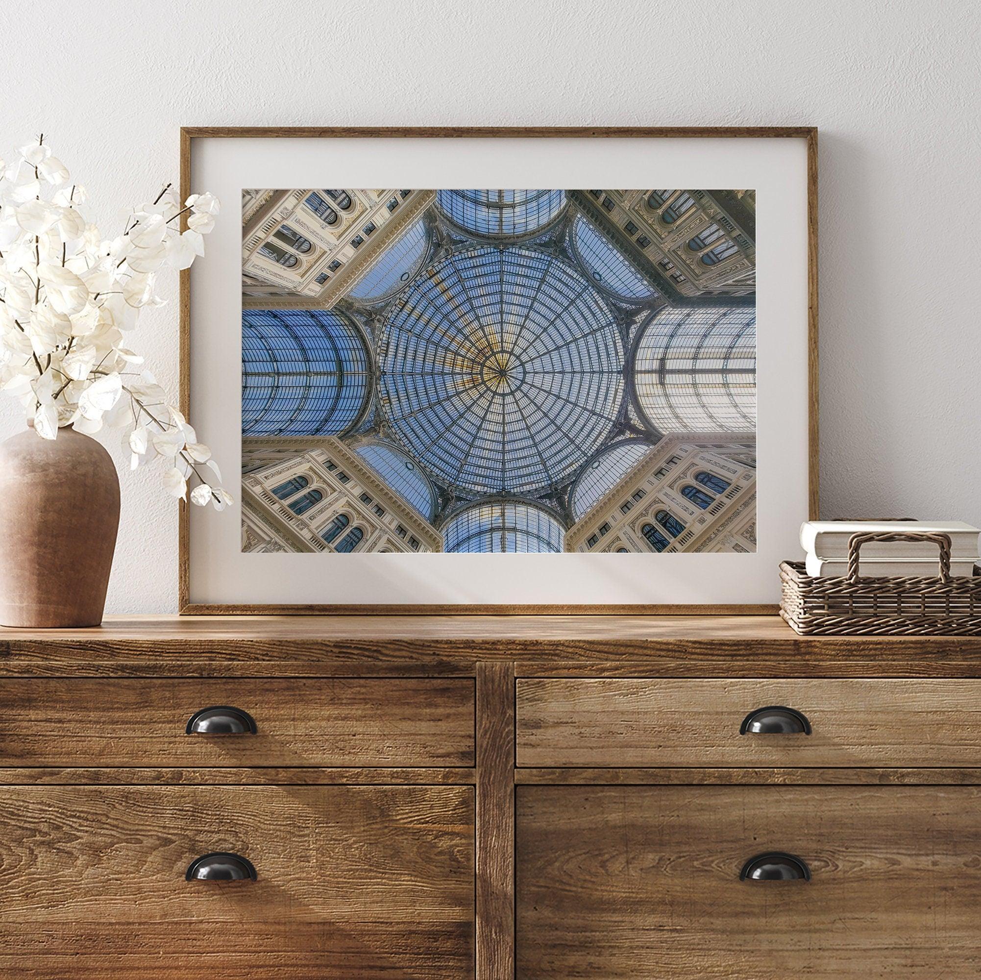 Framed fine art print featuring a symmetrical view of the glass and steel roof of the Galleria Umberto I, a historic building in Naples, Italy. The intricate geometric patterns create an abstract composition.