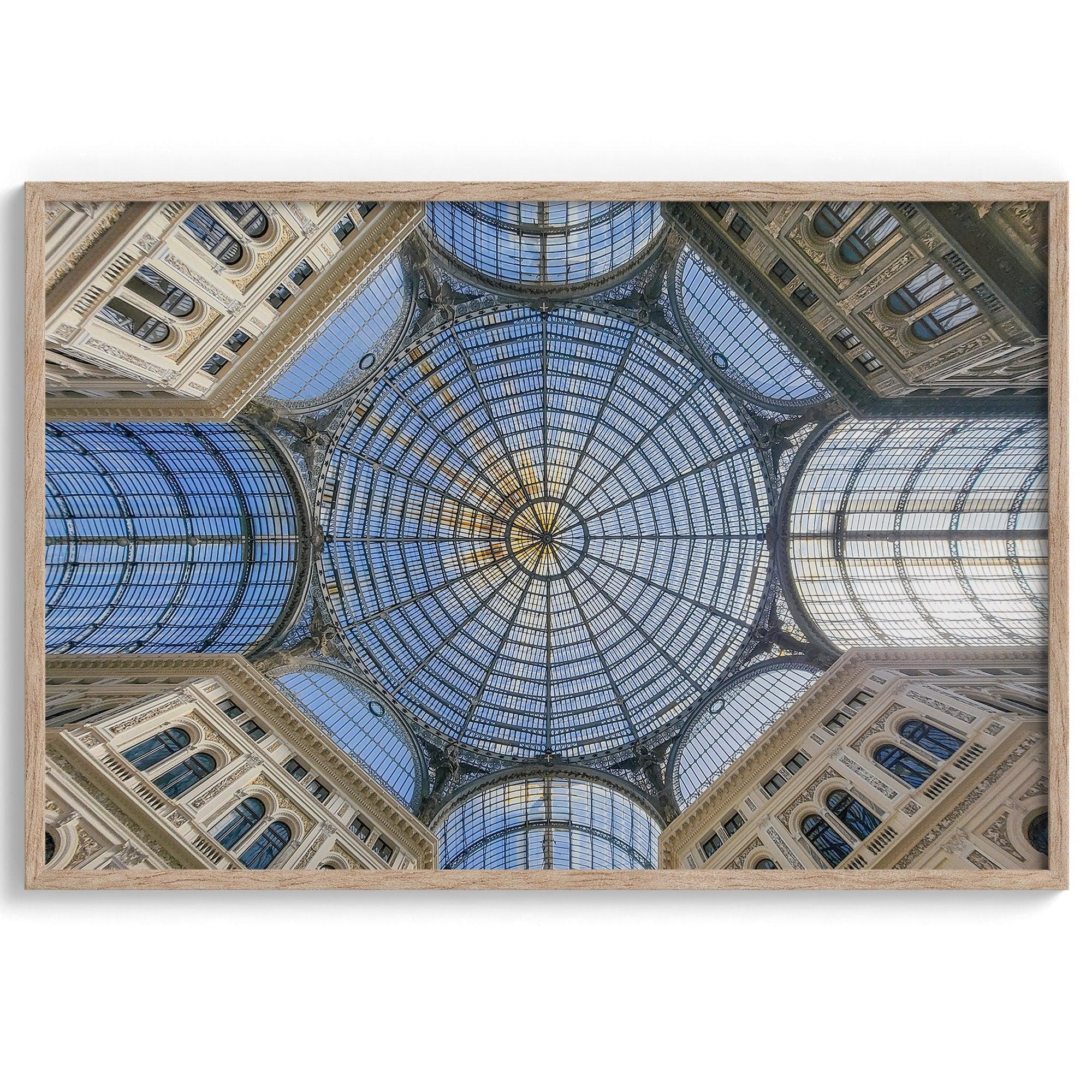 Framed fine art print featuring a symmetrical view of the glass and steel roof of the Galleria Umberto I, a historic building in Naples, Italy. The intricate geometric patterns create an abstract composition.