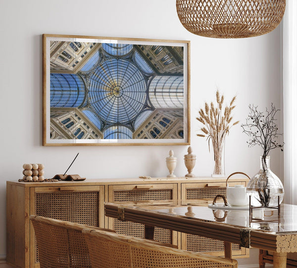 Framed fine art print featuring a symmetrical view of the glass and steel roof of the Galleria Umberto I, a historic building in Naples, Italy. The intricate geometric patterns create an abstract composition.