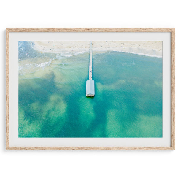 Aerial view fine art photography print of Hanalei Bay, showcasing Hanalei Pier jutting out into the ocean, surrounded by vibrant coral reefs, mesmerizing water patterns, and Hanalei Beach from a captivating bird eye perspective.