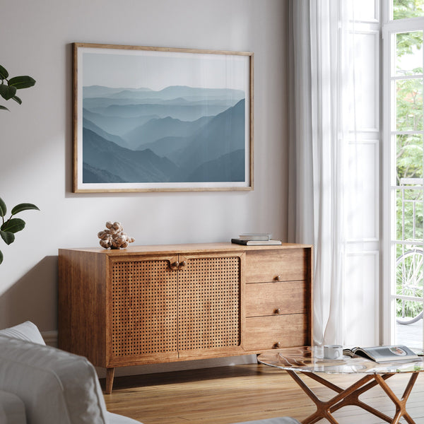A fine art mountain photography print showing tens of shaded mountains one after the other. This minimalist mountain range wall art is perfect for nature lovers.