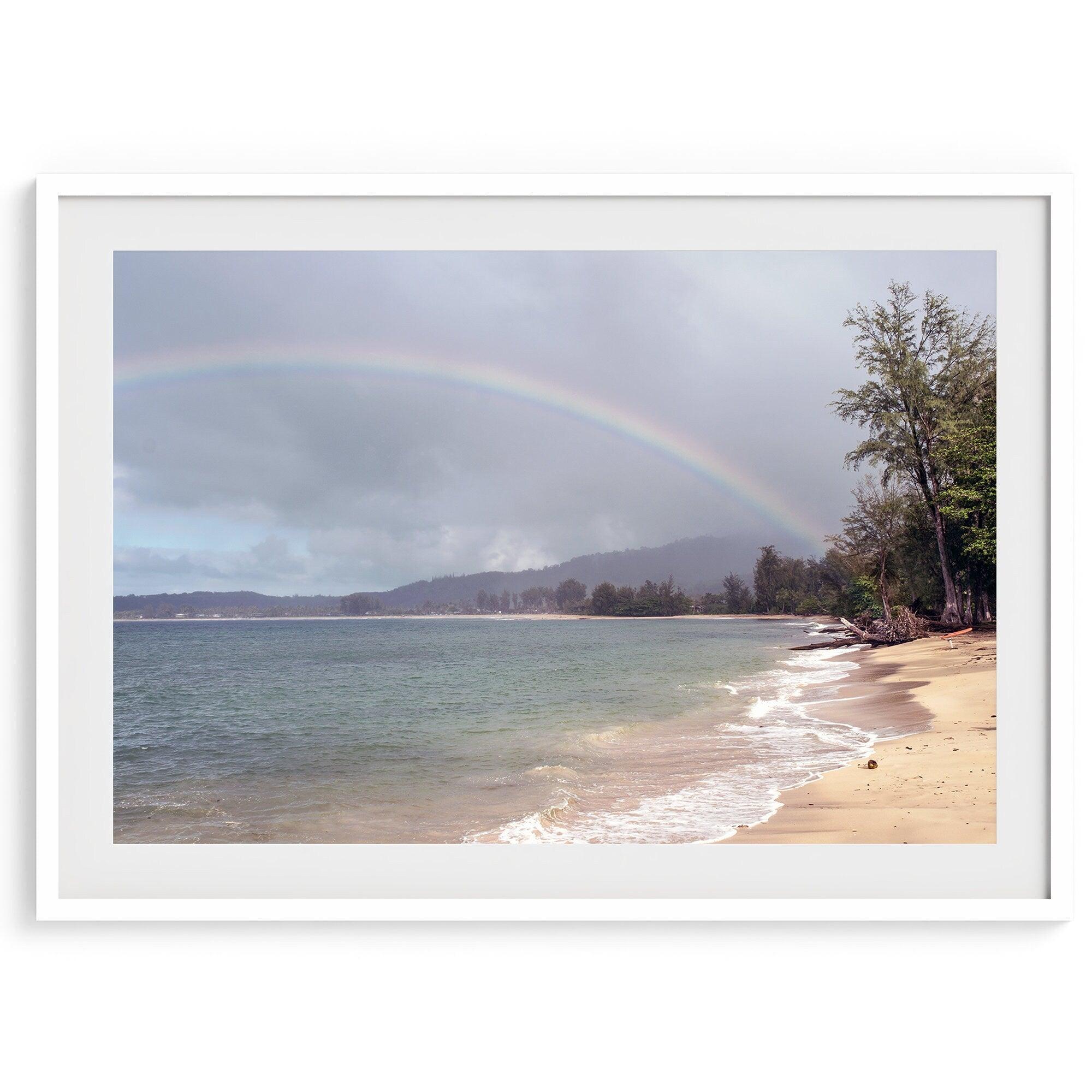 A framed or unframed beach fine art photography print showcasing a stunning tropical beach in Kauai, Hawai with a large breathtaking rainbow across it.