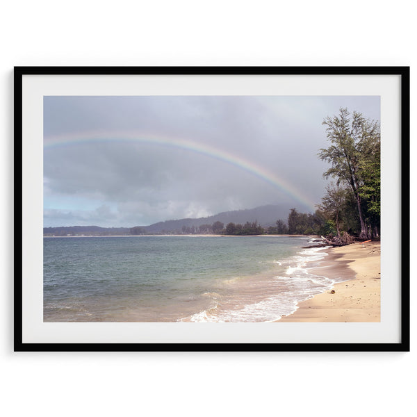A framed or unframed beach fine art photography print showcasing a stunning tropical beach in Kauai, Hawai with a large breathtaking rainbow across it.