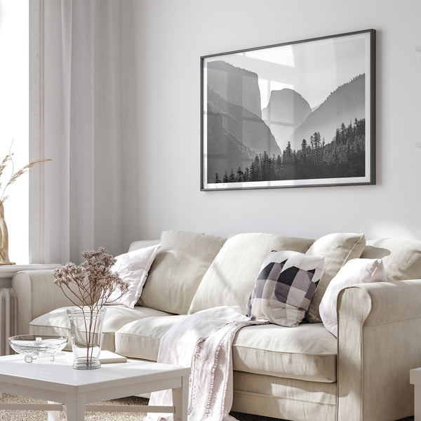 A black and white photography wall art of Yosemite Valley at sunset, featuring the iconic Half Dome and El Capitan bathed in dramatic light and shadow. Perfect for nature lovers and art enthusiasts.