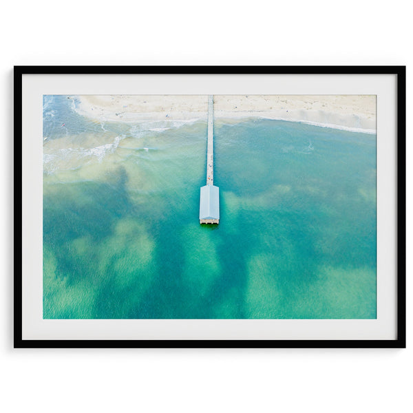 Aerial view fine art photography print of Hanalei Bay, showcasing Hanalei Pier jutting out into the ocean, surrounded by vibrant coral reefs, mesmerizing water patterns, and Hanalei Beach from a captivating bird eye perspective.