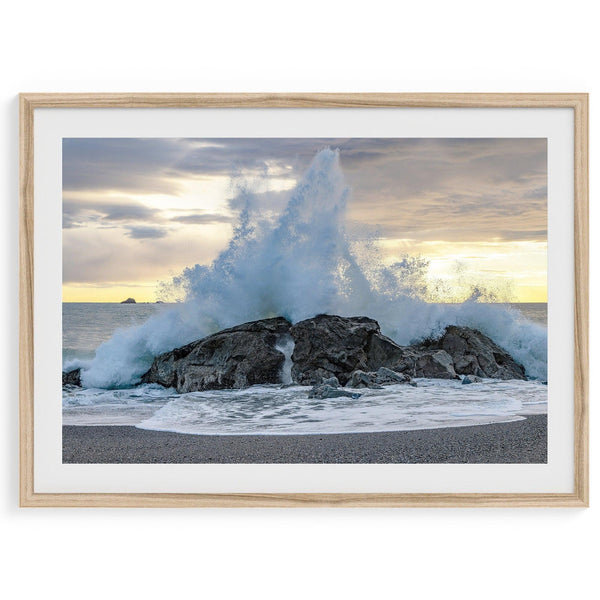 A dramatic fine art beach print showing a huge ocean wave crashing on a beautiful beach in California during sunset