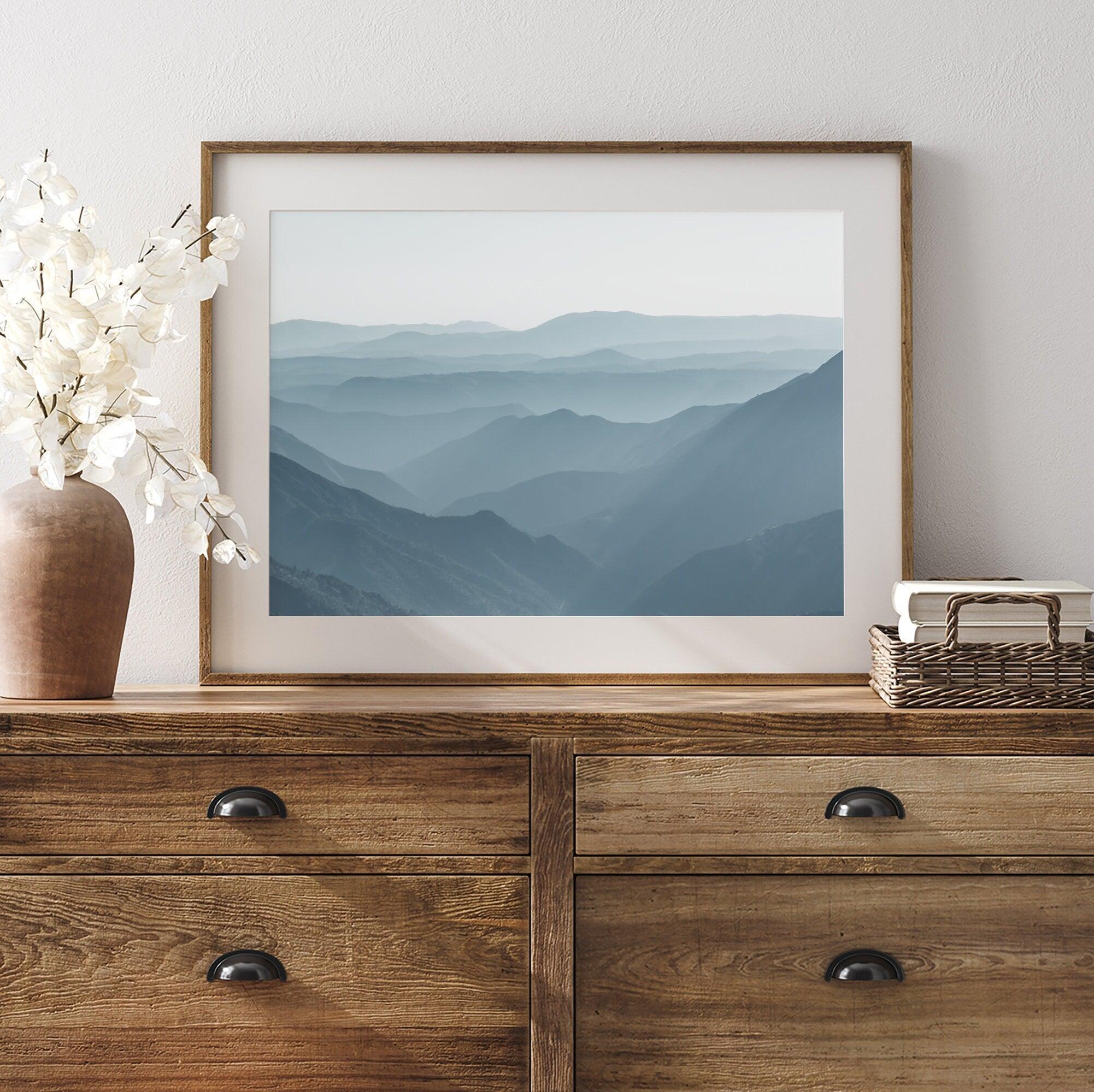 A fine art mountain photography print showing tens of shaded mountains one after the other. This minimalist mountain range wall art is perfect for nature lovers.