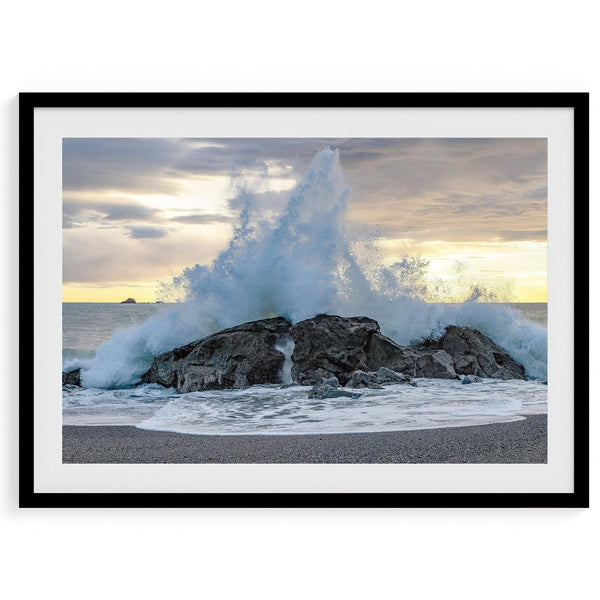 A dramatic fine art beach print showing a huge ocean wave crashing on a beautiful beach in California during sunset