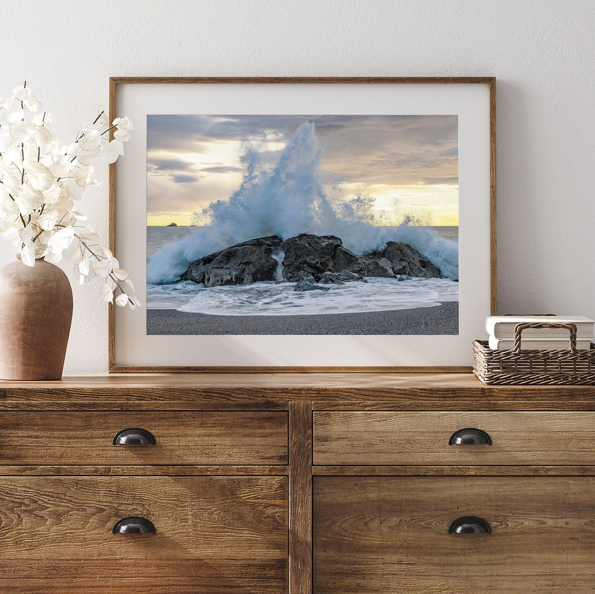 A dramatic fine art beach print showing a huge ocean wave crashing on a beautiful beach in California during sunset