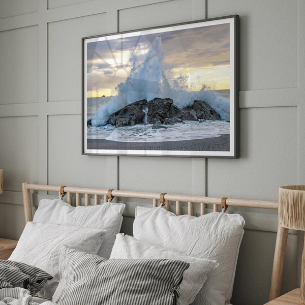 A dramatic fine art beach print showing a huge ocean wave crashing on a beautiful beach in California during sunset