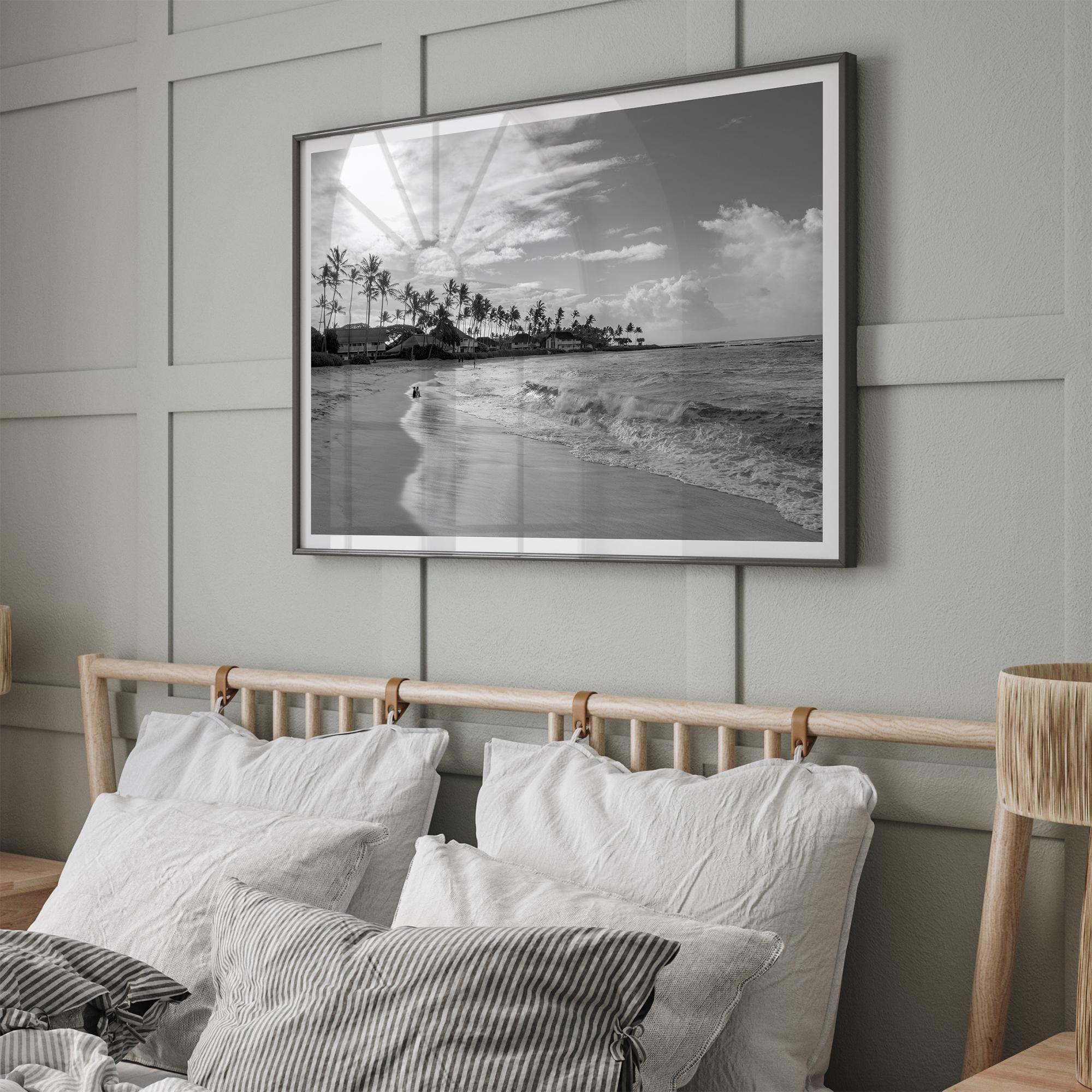 Black and white tropical wall art featuring a serene sunrise on a beach in Kauai, Hawaii with palm trees