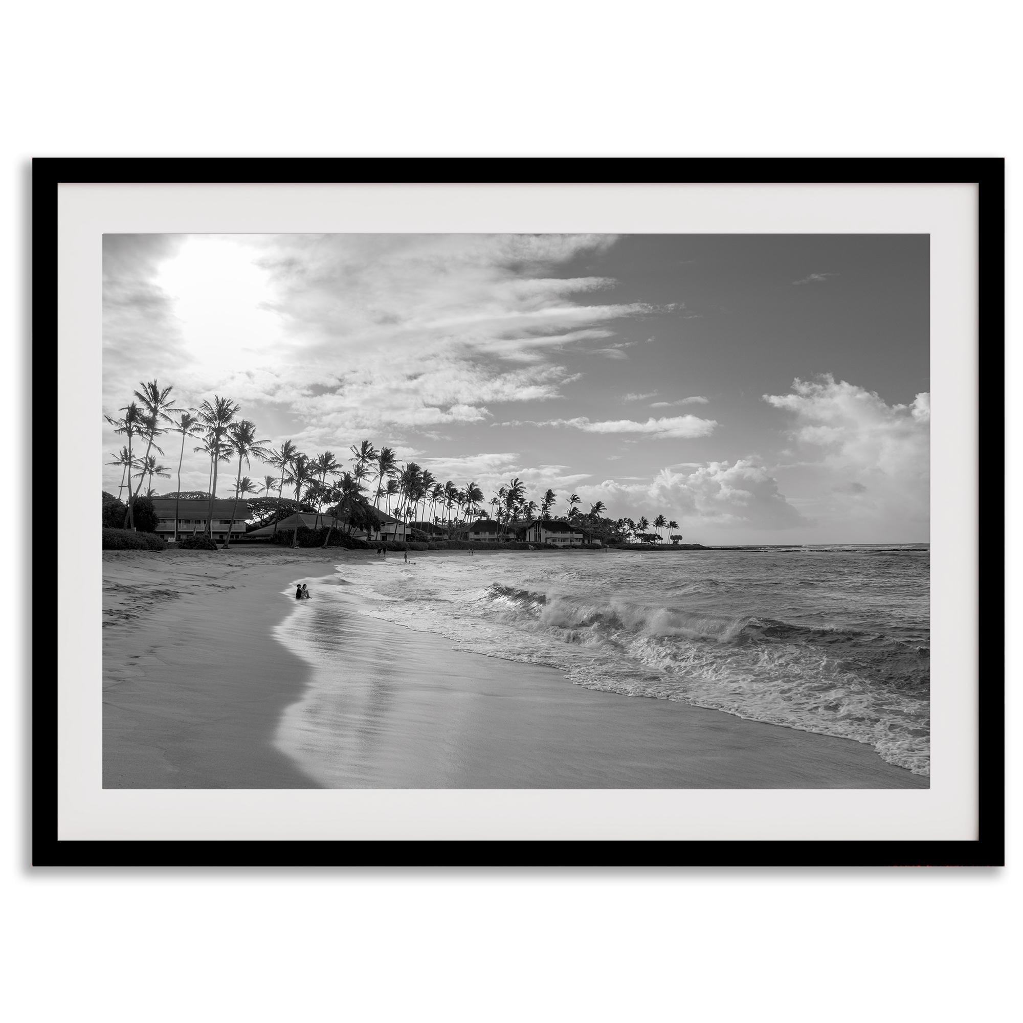 Black and white tropical wall art featuring a serene sunrise on a beach in Kauai, Hawaii with palm trees