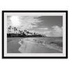 Black and white tropical wall art featuring a serene sunrise on a beach in Kauai, Hawaii with palm trees