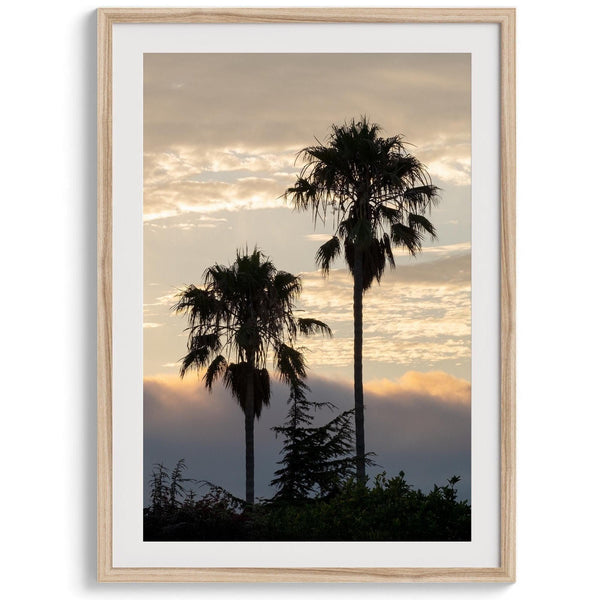 Palm tree wall art featuring two silhouetted palms at sunrise along a California beach.