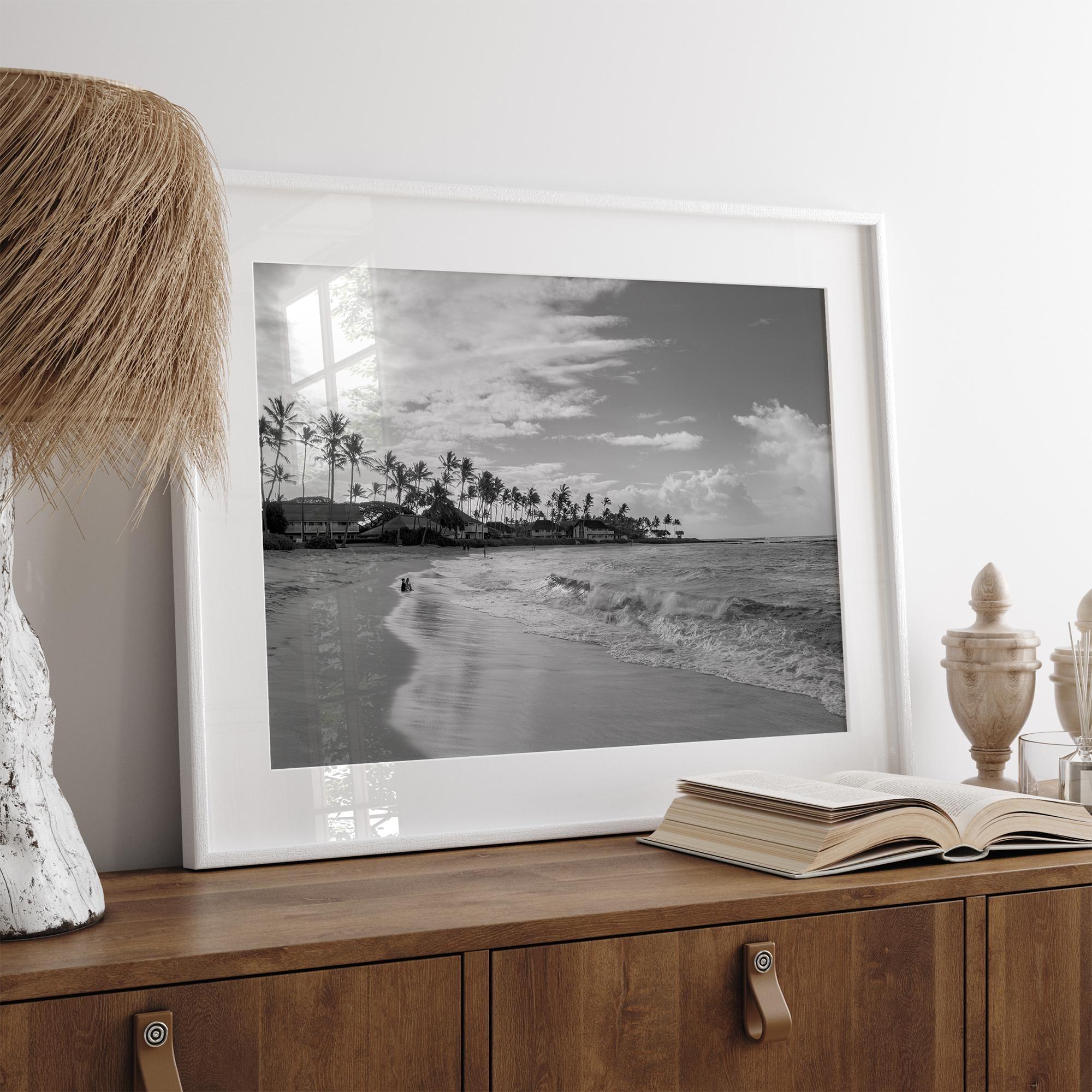 Black and white tropical wall art featuring a serene sunrise on a beach in Kauai, Hawaii with palm trees